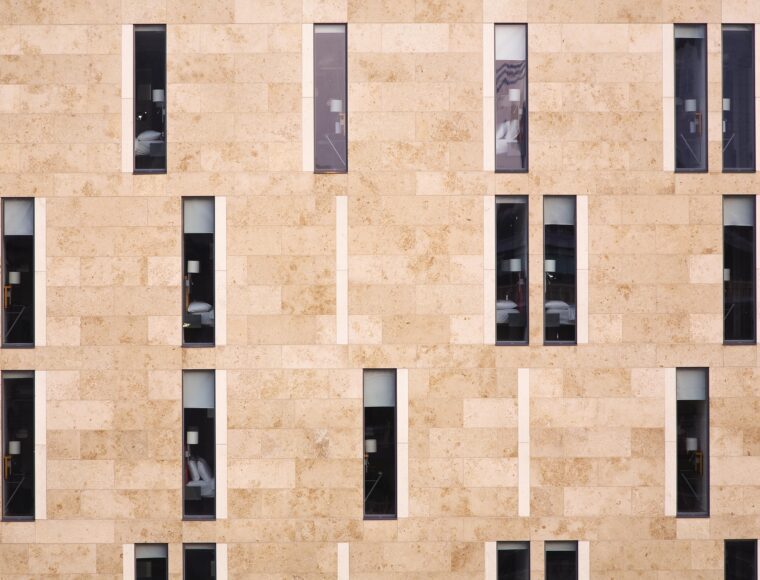 Exterior of an architectural hotel building, with long and slim windows.