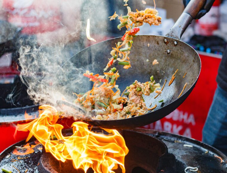 chef cooks Chinese noodle wok at Dundee food festival.
